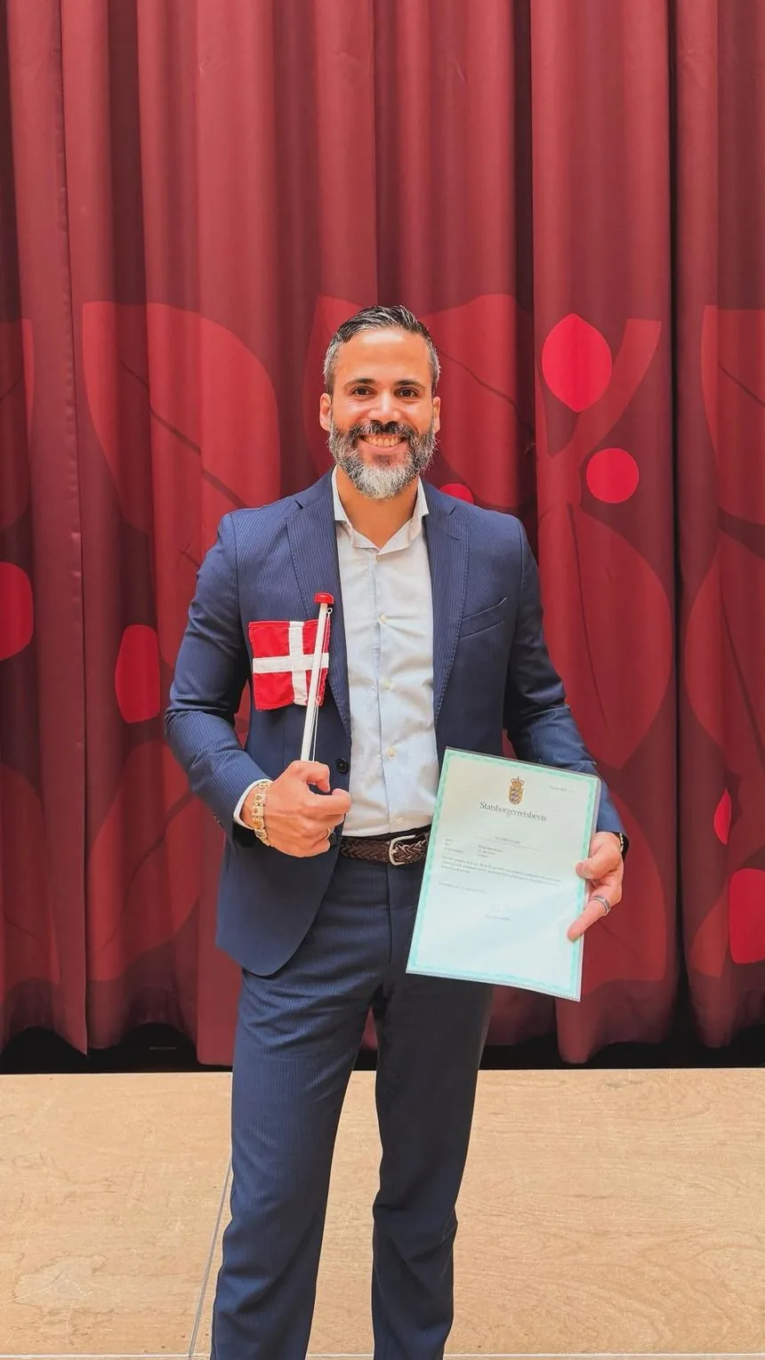 Jordi at the Danish citizenship ceremony, holding his certificate